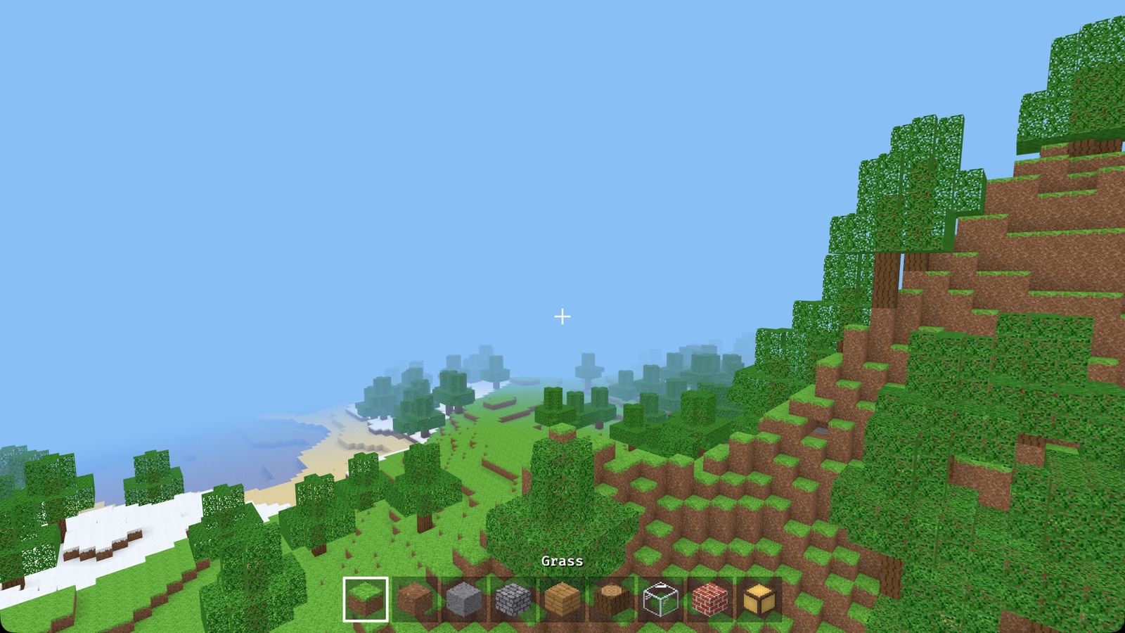 Hills with trees, a beach and the sea, all made of blocks
